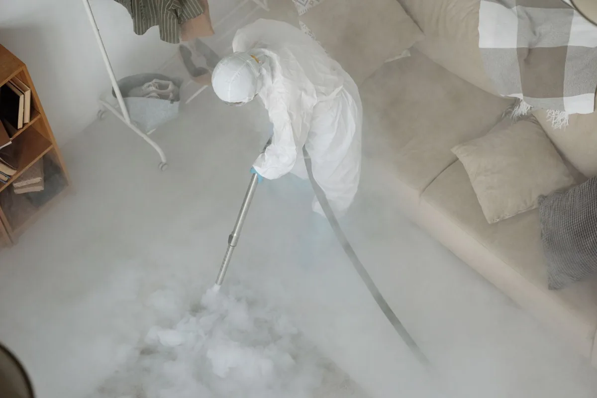 Biohazard cleanup technician in protective equipment, West University Place, TX